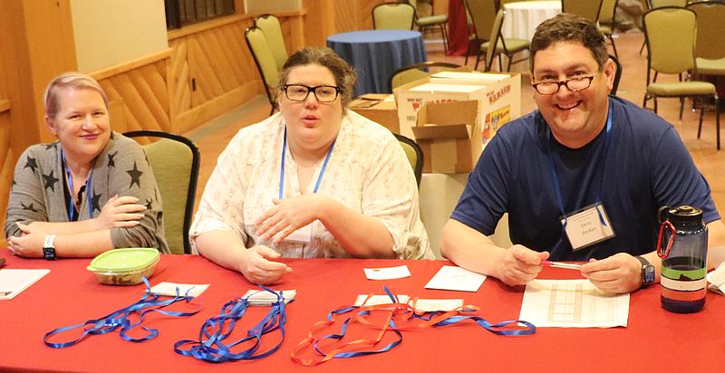 Crystal Noll, Heather Holloway, and Chris Zordan staff the registration table